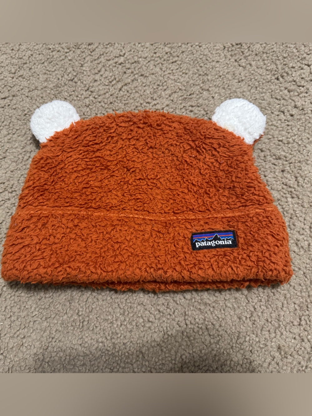Patagonia Kids Orange Fuzzy Beanie with White Ear Poms